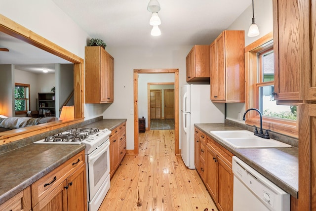 31338 Oasis Rd, Center City, MN 55012 - kitchen featuring white appliances, dark countertops, light wood-style flooring, hanging light fixtures, and brown cabinets