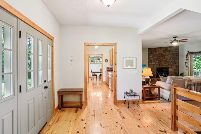 31338 Oasis Rd, Center City, MN 55012 - entryway with light wood finished floors, a ceiling fan, and a fireplace