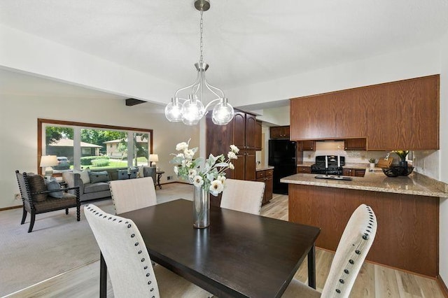 1821 Wilson Ave, Saint Paul, MN 55106 - dining space featuring a chandelier and light wood-style flooring