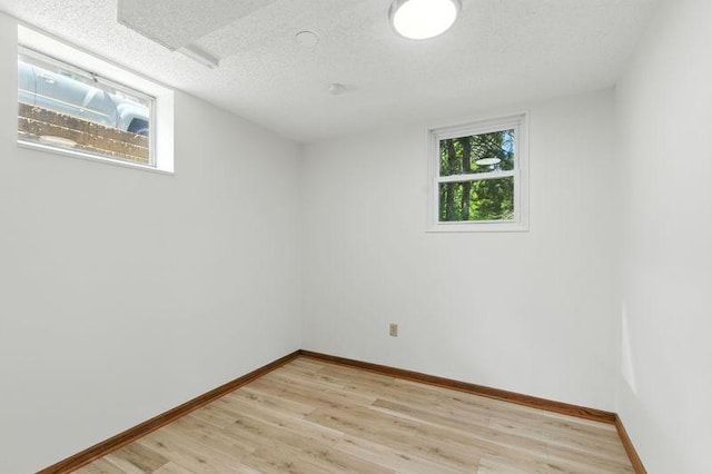 1821 Wilson Ave, Saint Paul, MN 55106 - empty room with light wood-style floors and a textured ceiling