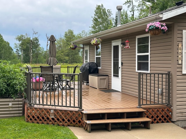 406 State 6 S, Remer, MN 56672 - wooden terrace featuring outdoor dining area and a grill
