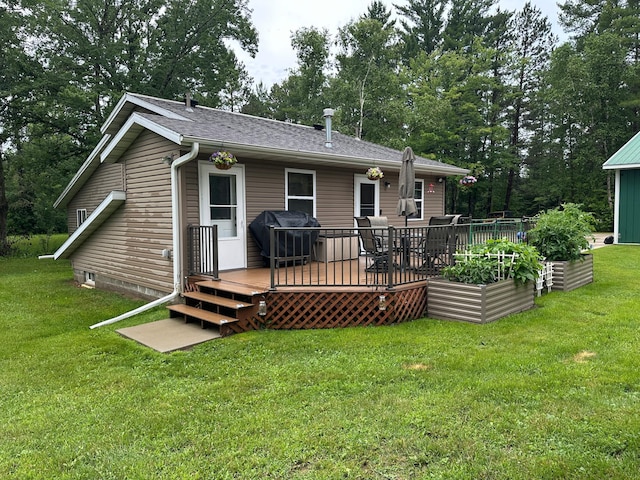 406 State 6 S, Remer, MN 56672 - rear view of property featuring a wooden deck, a yard, a shingled roof, and view of scattered trees