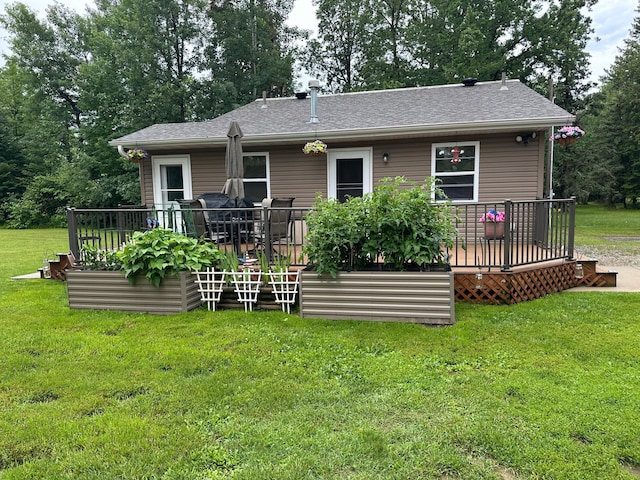 406 State 6 S, Remer, MN 56672 - rear view of property with a wooden deck, a lawn, and a shingled roof