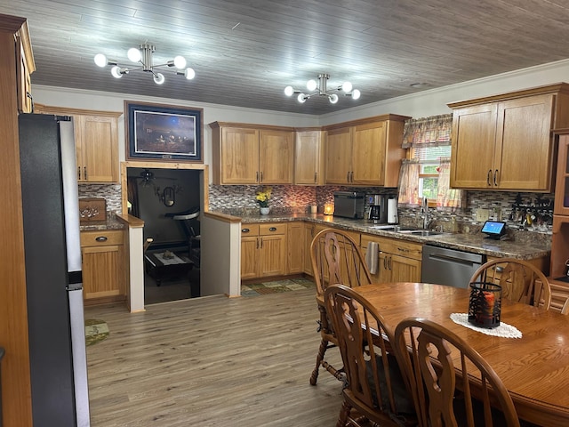 406 State 6 S, Remer, MN 56672 - kitchen featuring stainless steel appliances, a chandelier, crown molding, backsplash, and light wood-type flooring