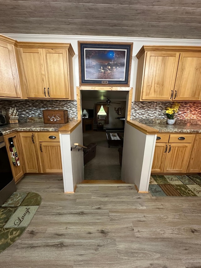 406 State 6 S, Remer, MN 56672 - kitchen with decorative backsplash, light wood-type flooring, dark countertops, and stove
