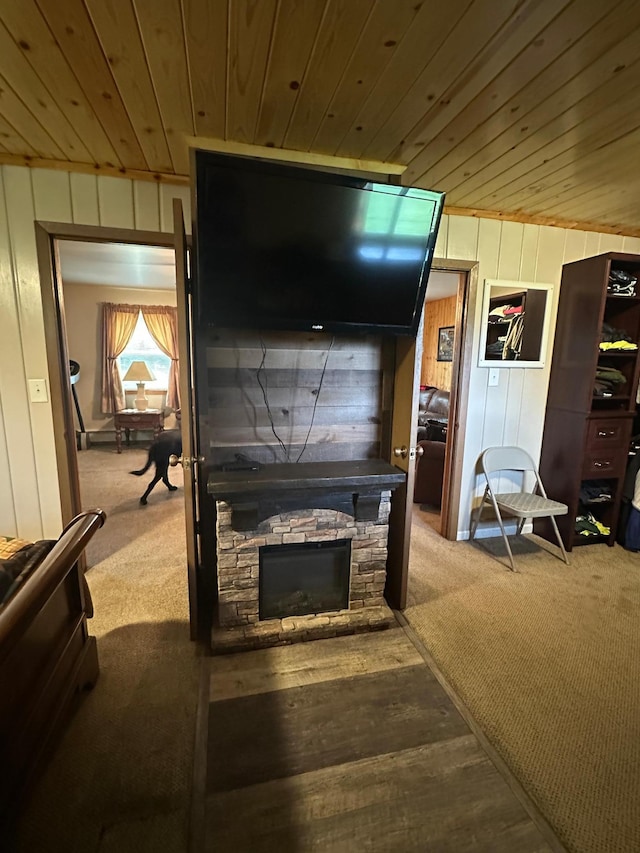 406 State 6 S, Remer, MN 56672 - carpeted living area with wooden ceiling, wooden walls, and a fireplace