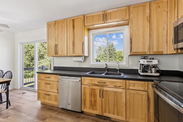3205 Adair Ave NE, Buffalo, MN 55313 - kitchen with appliances with stainless steel finishes, dark countertops, wood finished floors, and a ceiling fan