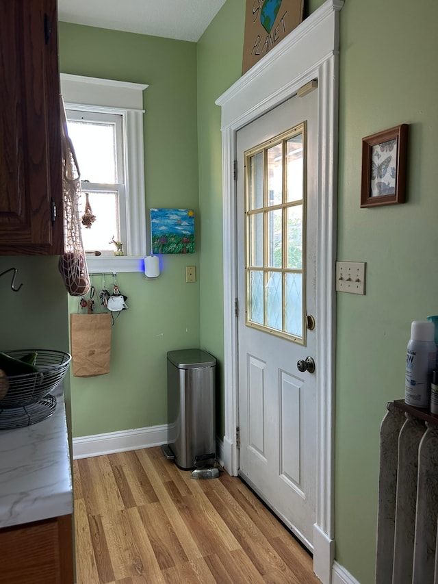 1636 Minnehaha Ave W, Saint Paul, MN 55104 - doorway to outside featuring light wood-style flooring and baseboards