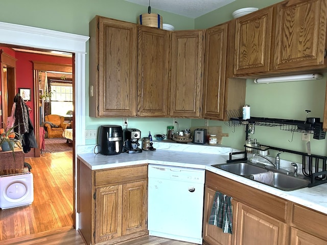 1636 Minnehaha Ave W, Saint Paul, MN 55104 - kitchen featuring dishwasher, light countertops, light wood finished floors, and brown cabinetry