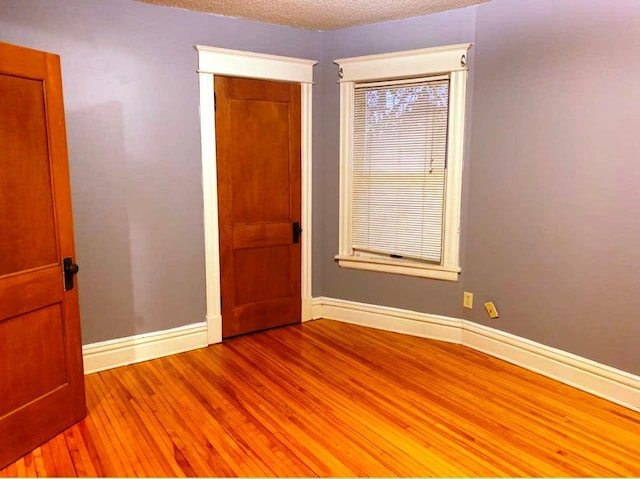 1636 Minnehaha Ave W, Saint Paul, MN 55104 - unfurnished room with wood finished floors and a textured ceiling