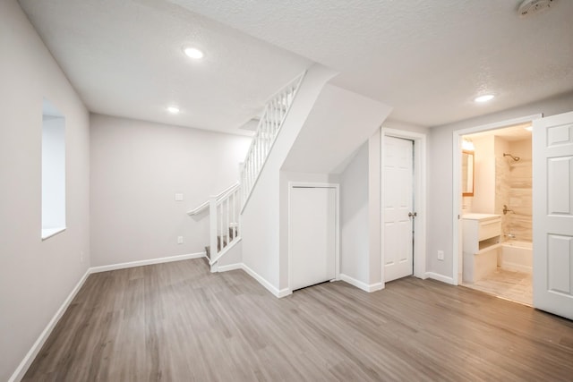 3624 15th Ave S, Minneapolis, MN 55407 - additional living space with wood finished floors, stairs, recessed lighting, and a textured ceiling