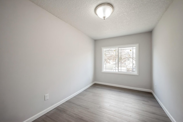 3624 15th Ave S, Minneapolis, MN 55407 - empty room featuring a textured ceiling and wood finished floors