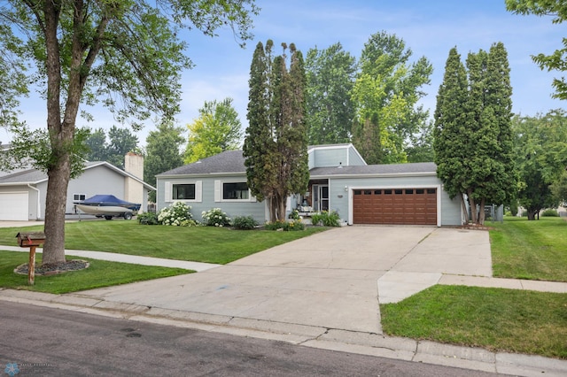 3402 Par St N, Fargo, ND 58102 - view of front of home with an attached garage, a front yard, and driveway