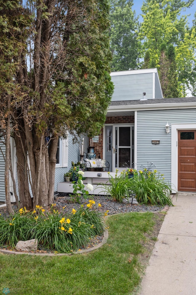 3402 Par St N, Fargo, ND 58102 - view of front facade featuring an attached garage and roof with shingles