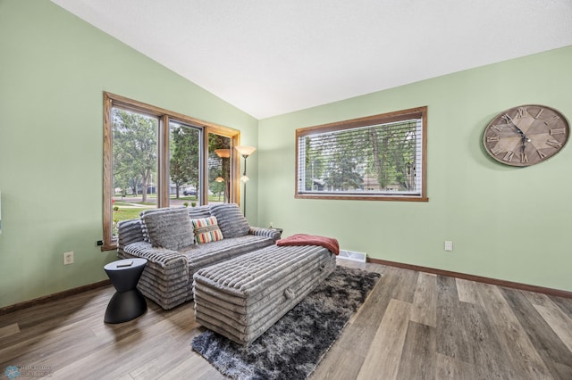 3402 Par St N, Fargo, ND 58102 - living area featuring healthy amount of natural light, vaulted ceiling, and wood finished floors
