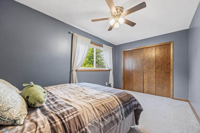 3402 Par St N, Fargo, ND 58102 - carpeted bedroom with a textured ceiling, a ceiling fan, and a closet