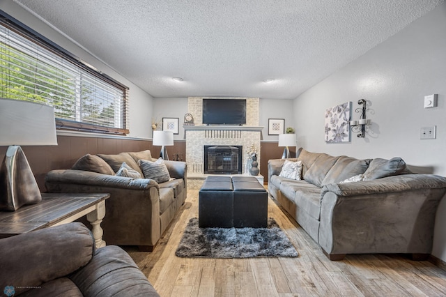 3402 Par St N, Fargo, ND 58102 - living room with a textured ceiling, hardwood / wood-style floors, and a fireplace
