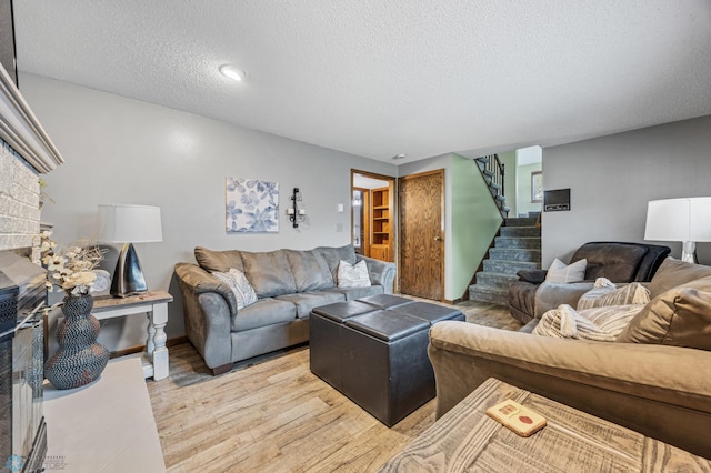 3402 Par St N, Fargo, ND 58102 - living room featuring a textured ceiling, stairway, and light wood-type flooring