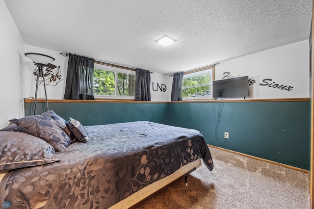 3402 Par St N, Fargo, ND 58102 - carpeted bedroom featuring a textured ceiling and baseboards