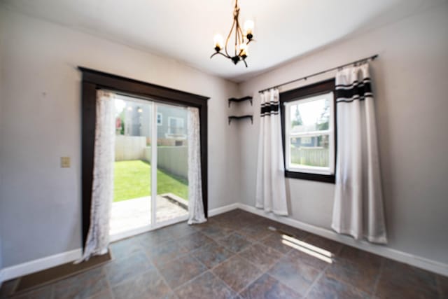517 Elm St, Mankato, MN 56001 - unfurnished dining area with a chandelier and stone finish flooring