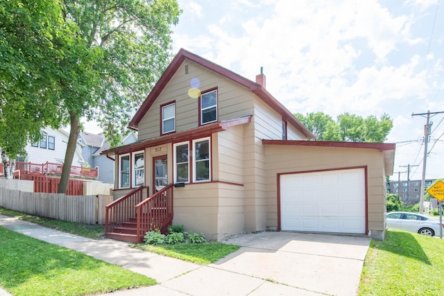 517 Elm St, Mankato, MN 56001 - view of front of home with concrete driveway, a chimney, and an attached garage
