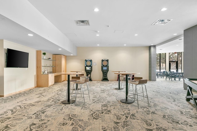 1240 2nd St Unit 225, Minneapolis, MN 55415 - rec room featuring light carpet, recessed lighting, a wall of windows, and a community bar