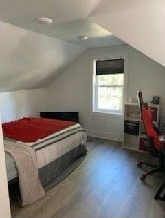 421 8th St, Cloquet, MN 55720 - bedroom with lofted ceiling, a desk, and wood finished floors