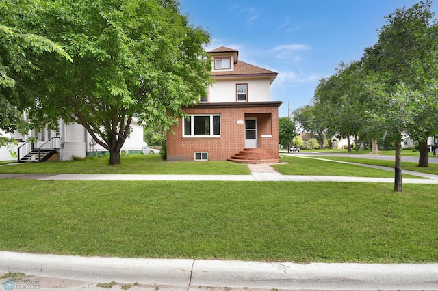51 6th Ave N, Fargo, ND 58102 - traditional style home featuring brick siding and a front yard