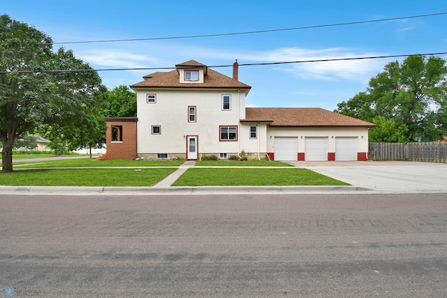 51 6th Ave N, Fargo, ND 58102 - view of front of house featuring an attached garage, a chimney, driveway, and stucco siding