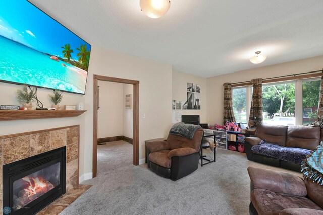 51 6th Ave N, Fargo, ND 58102 - carpeted living area with a tile fireplace and baseboards