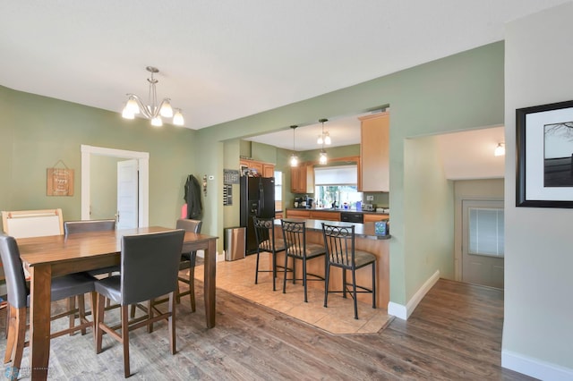 51 6th Ave N, Fargo, ND 58102 - dining space with light wood-style floors and a chandelier