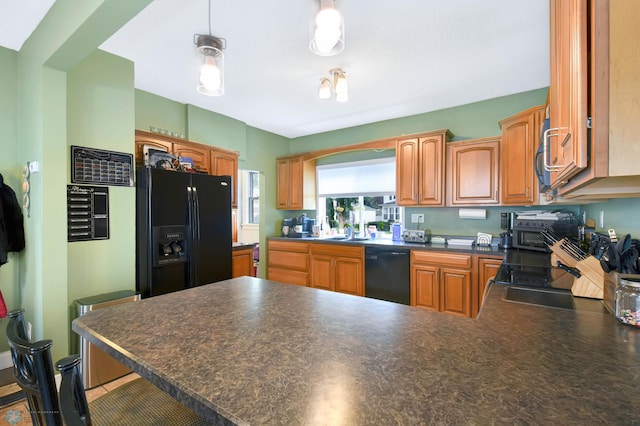 51 6th Ave N, Fargo, ND 58102 - kitchen with black appliances, a peninsula, dark countertops, and brown cabinets