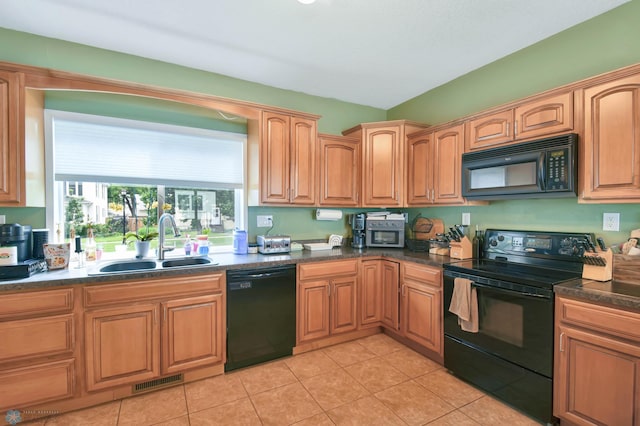 51 6th Ave N, Fargo, ND 58102 - kitchen featuring black appliances, dark countertops, and light tile patterned floors