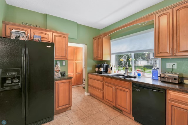 51 6th Ave N, Fargo, ND 58102 - kitchen featuring black appliances, dark countertops, light tile patterned flooring, and brown cabinets