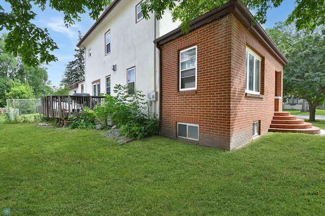 51 6th Ave N, Fargo, ND 58102 - view of home's exterior featuring a lawn, brick siding, and a deck