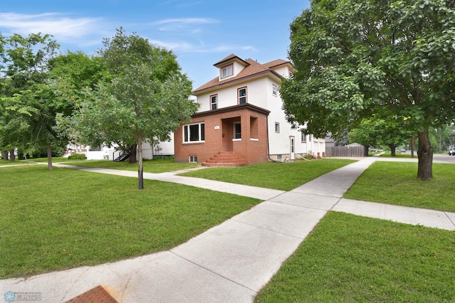 51 6th Ave N, Fargo, ND 58102 - american foursquare style home featuring a front yard and brick siding