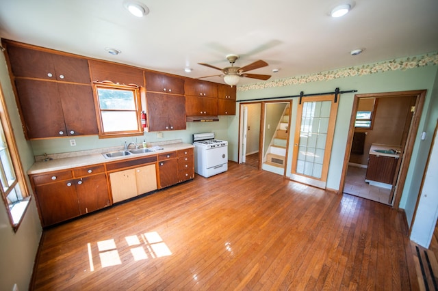 415 Minnesota Ave S, Oronoco, MN 55960 - kitchen with gas range gas stove, ceiling fan, light wood finished floors, and light countertops