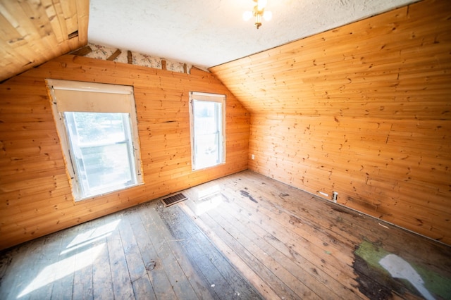 415 Minnesota Ave S, Oronoco, MN 55960 - additional living space with vaulted ceiling, hardwood / wood-style floors, and wooden walls