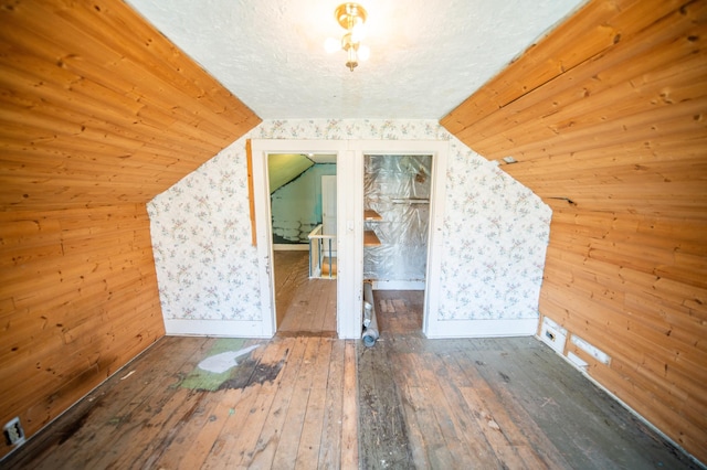 415 Minnesota Ave S, Oronoco, MN 55960 - additional living space featuring hardwood / wood-style floors, lofted ceiling, wooden walls, and wallpapered walls
