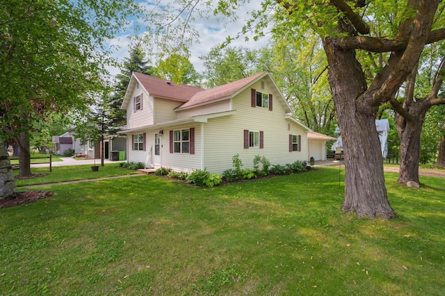 400 Mill St, Loyal, WI 54446 - view of side of property featuring a lawn and a garage