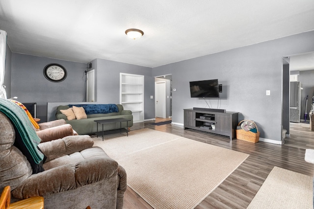 400 Mill St, Loyal, WI 54446 - living area with built in shelves and wood finished floors