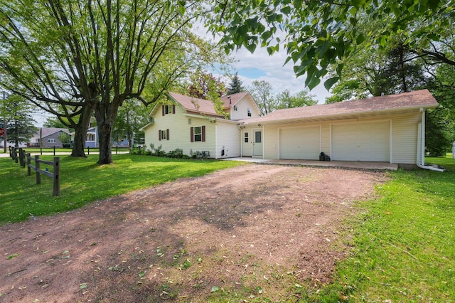 400 Mill St, Loyal, WI 54446 - view of front of home featuring dirt driveway, a garage, and a front yard