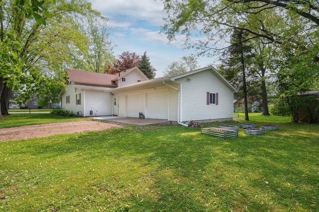 400 Mill St, Loyal, WI 54446 - rear view of house with an attached garage, a yard, and driveway
