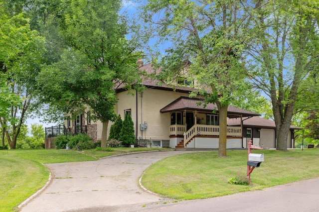 9691 Kadler Ave NE, Otsego, MN 55362 - view of front of house featuring covered porch, a front yard, driveway, and a chimney