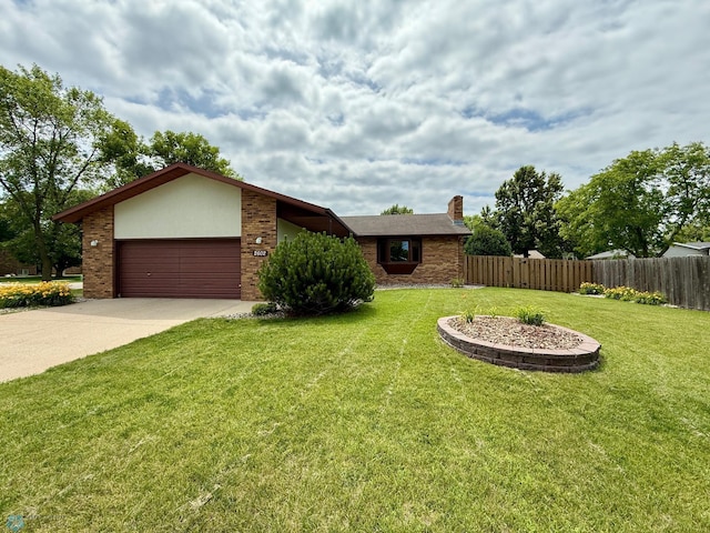2602 Eastgate Dr S, Fargo, ND 58103 - view of front of house with driveway, a garage, a chimney, and brick siding