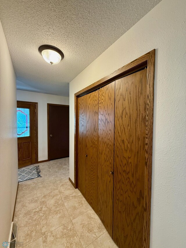 2602 Eastgate Dr S, Fargo, ND 58103 - hallway with a textured ceiling and light tile patterned flooring