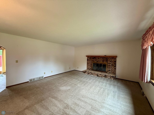 2602 Eastgate Dr S, Fargo, ND 58103 - unfurnished living room featuring carpet and a brick fireplace