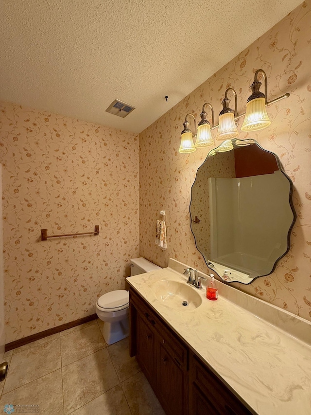 2602 Eastgate Dr S, Fargo, ND 58103 - bathroom with a textured ceiling, vanity, and tile patterned floors
