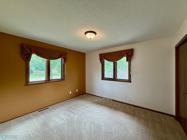 2602 Eastgate Dr S, Fargo, ND 58103 - carpeted empty room with a textured ceiling and baseboards