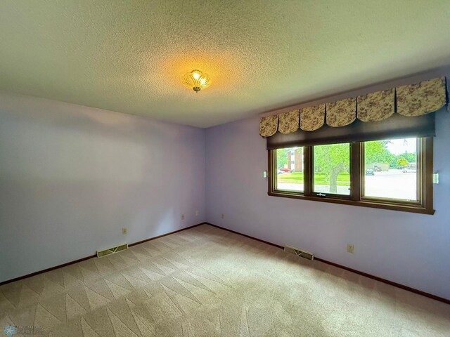 2602 Eastgate Dr S, Fargo, ND 58103 - empty room with light carpet and a textured ceiling